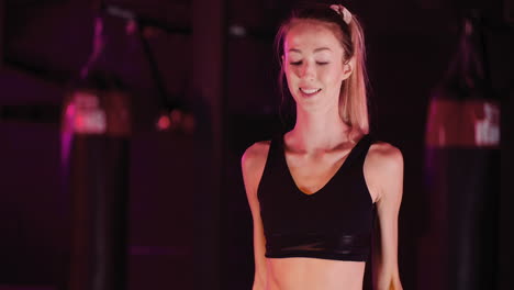 Confident-Female-Athlete-Doing-Exercise-With-Dumbbells-During-Fitness-Training-At-Gym