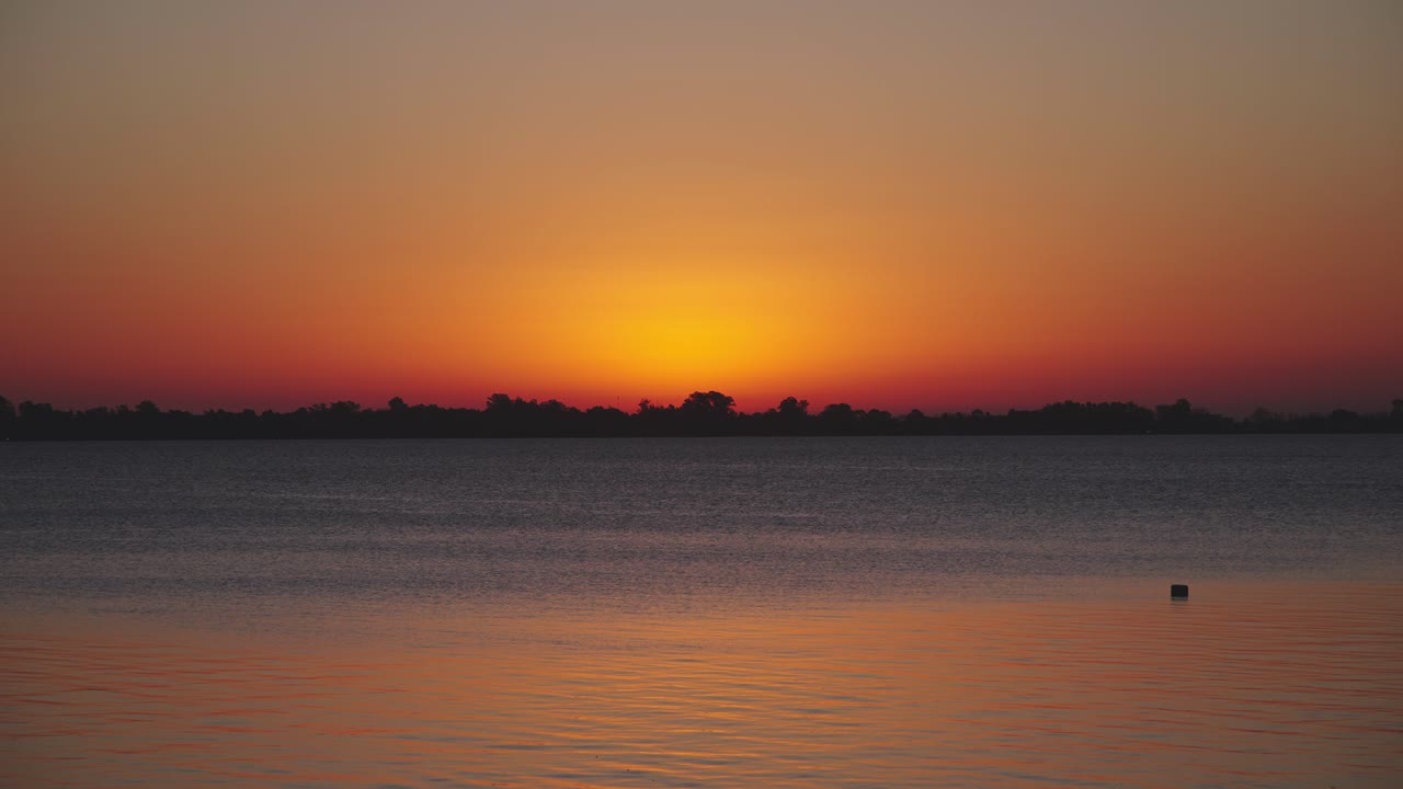 Vibrant Golden Sunset Reflecting on Calm Water