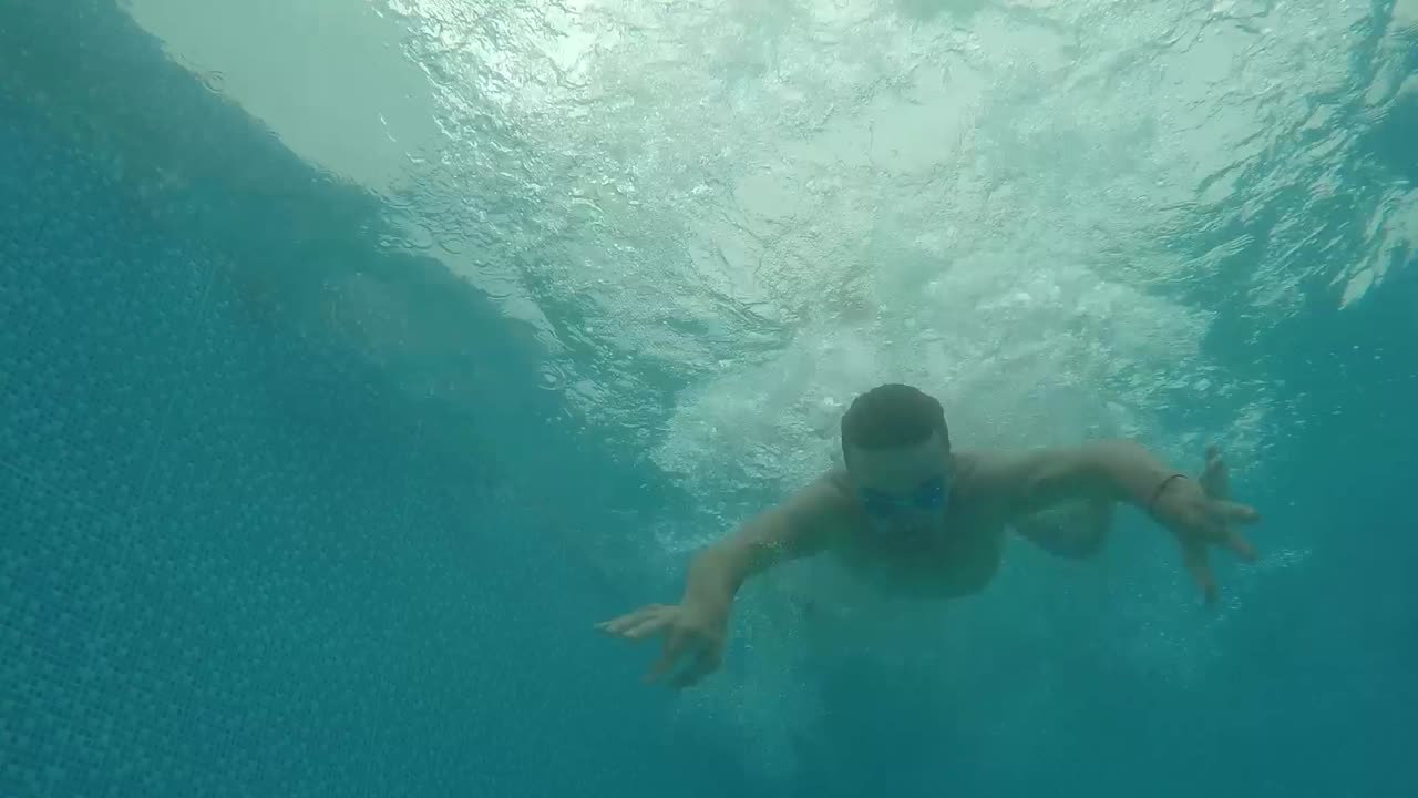 Underwater scene of a person swimming in a pool