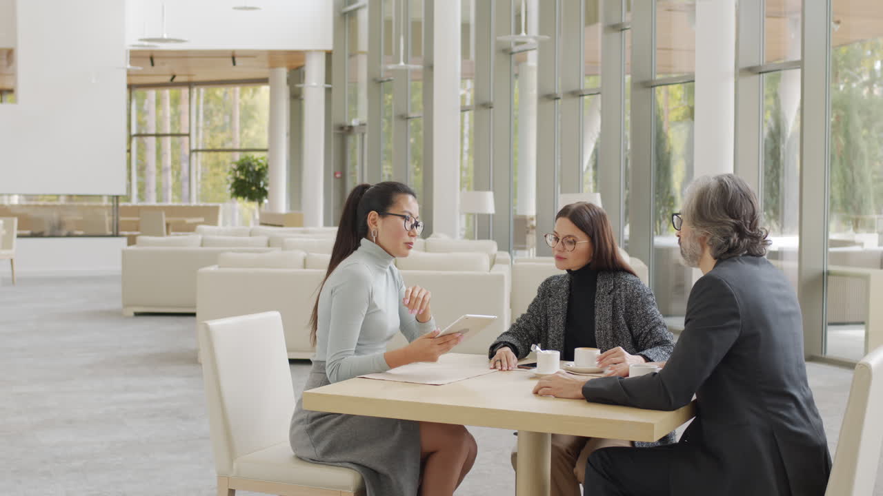 Multi-Ethnic Business Partners Having Meeting At Restaurant