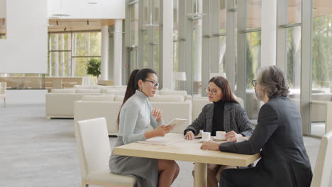 multi-ethnic business partners having meeting at restaurant