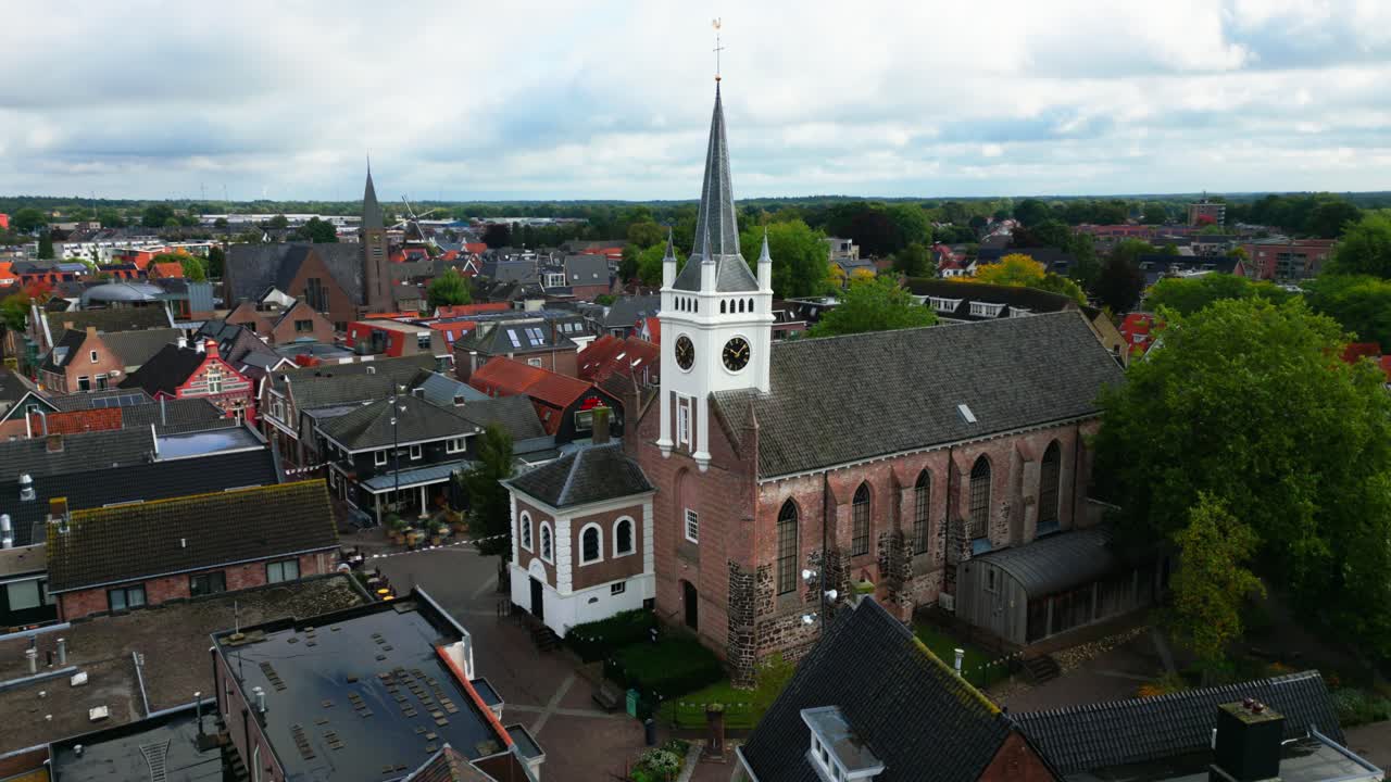 Panoramic aerial view of Ommen featuring white church spire, tiled houses, and compact streets. Captured in Ommen, Overijssel, Netherlands (Ommen, Overijssel, Nederland)
