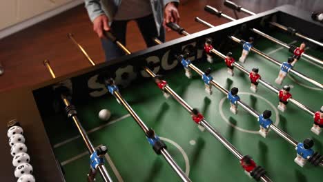 person playing foosball game