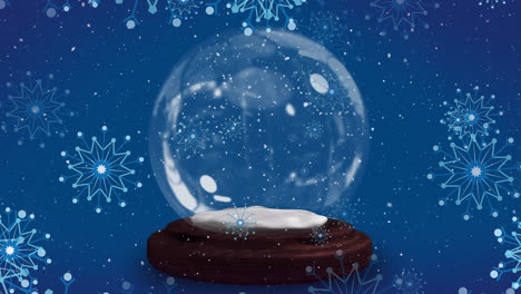 animación de copos de nieve navideños cayendo sobre un globo de nieve sobre un fondo azul