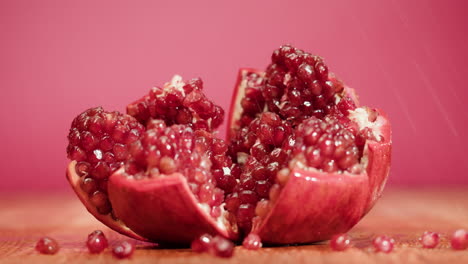 close-up of a cut pomegranate with water droplets