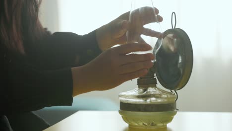 Woman-With-Old-Gas-Lantern-On-The-Table---Close-Up