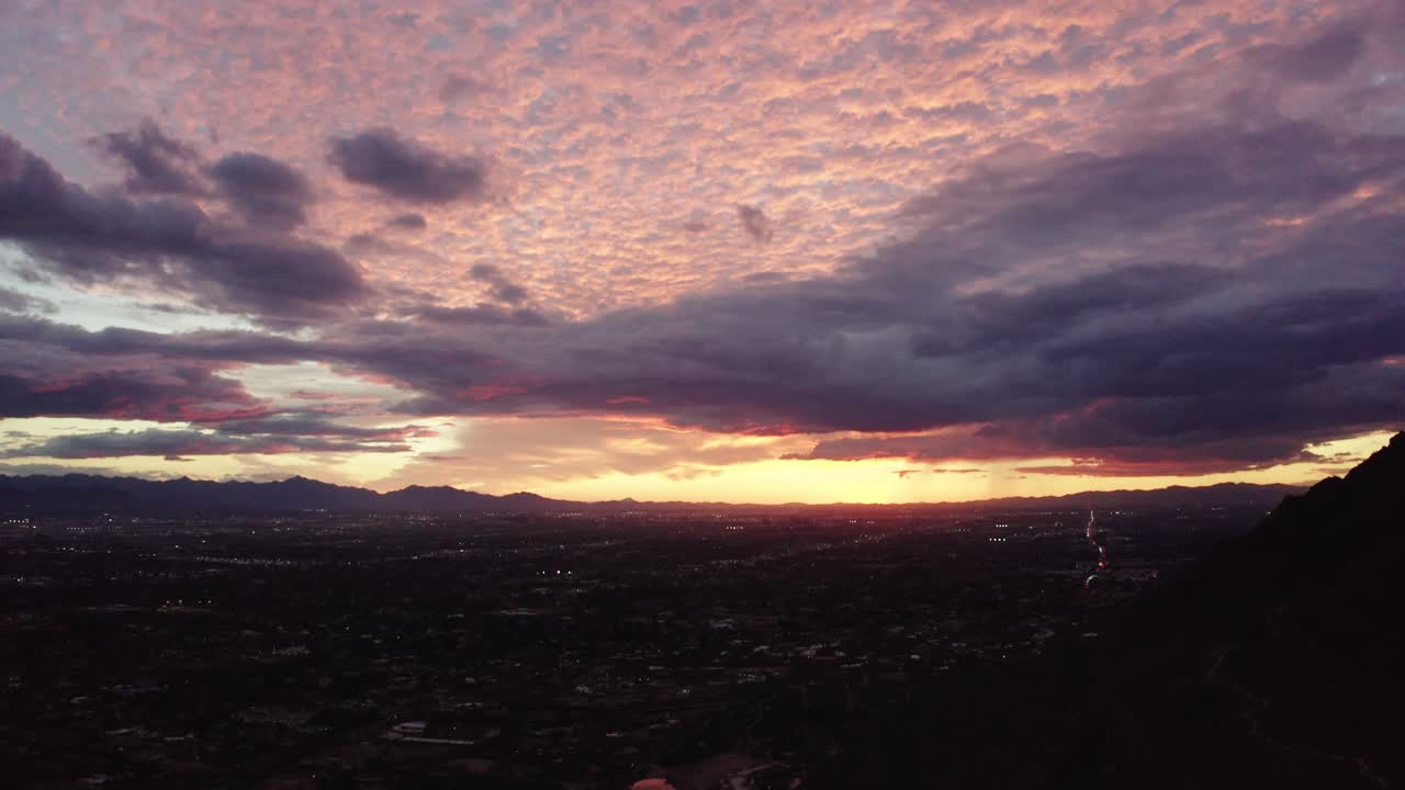 Tilting up shot from Scottsdale, Arizona to a beautiful sunlit pink sky