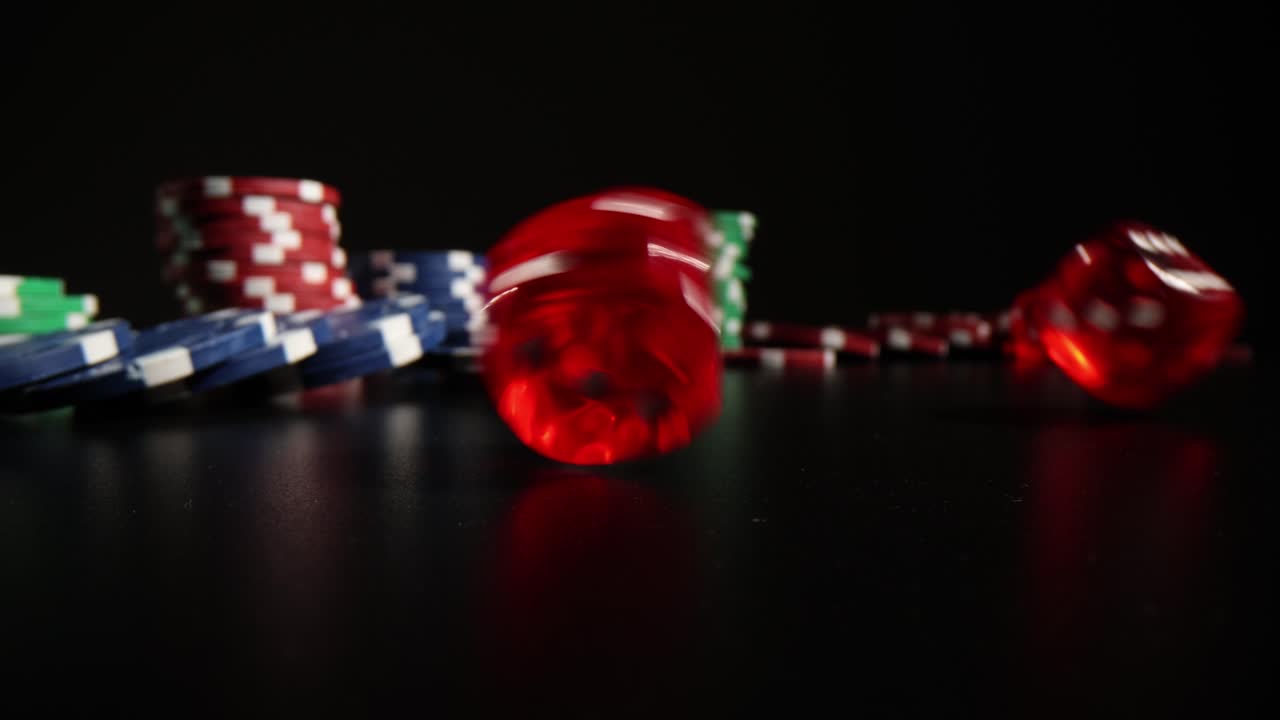 Poker Chips and Dice on Black Background