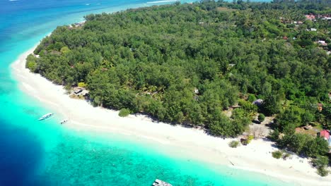 Paradise-vacation-location-on-tropical-island-of-Bali-with-lush-vegetation-and-white-sandy-beach-washed-by-beautiful-blue-turquoise-lagoon