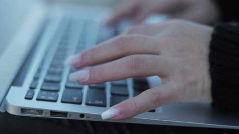 Primer-Plano-De-Manos-Femeninas-Escribiendo-En-El-Teclado-De-La-Computadora-Portátil