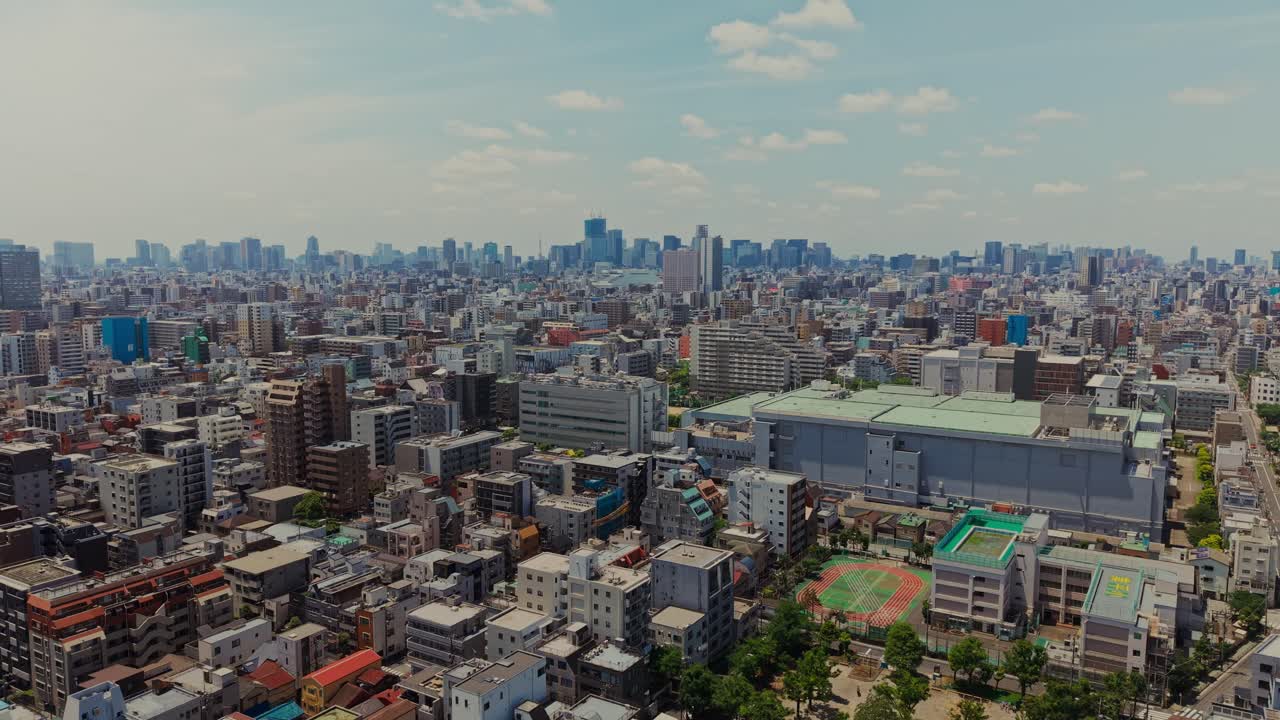 Aerial view of a sprawling city on a sunny day