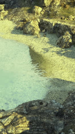 coastal landscape with clear water and rocky shoreline at dawn