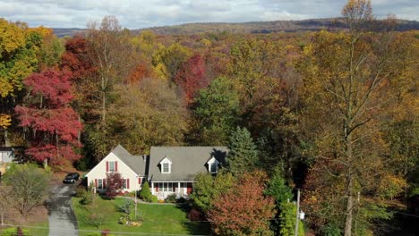 cape cod home in colorful woods