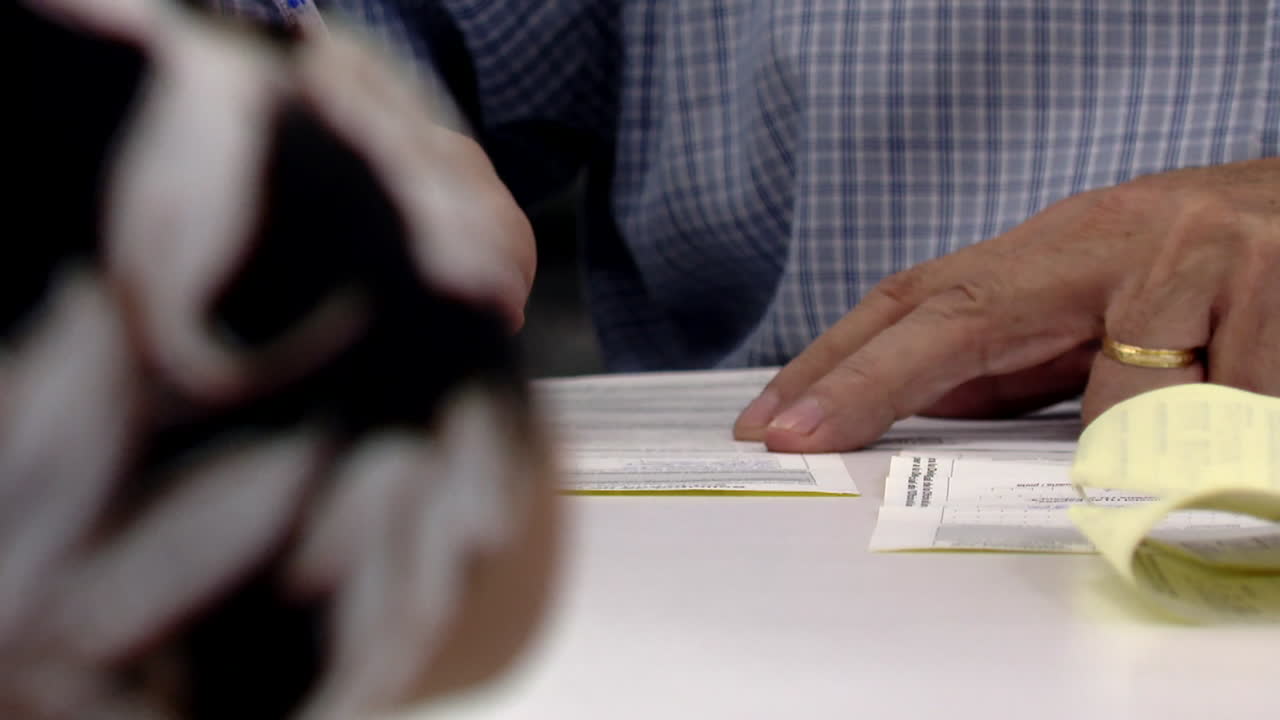 Person Filling Out Documents