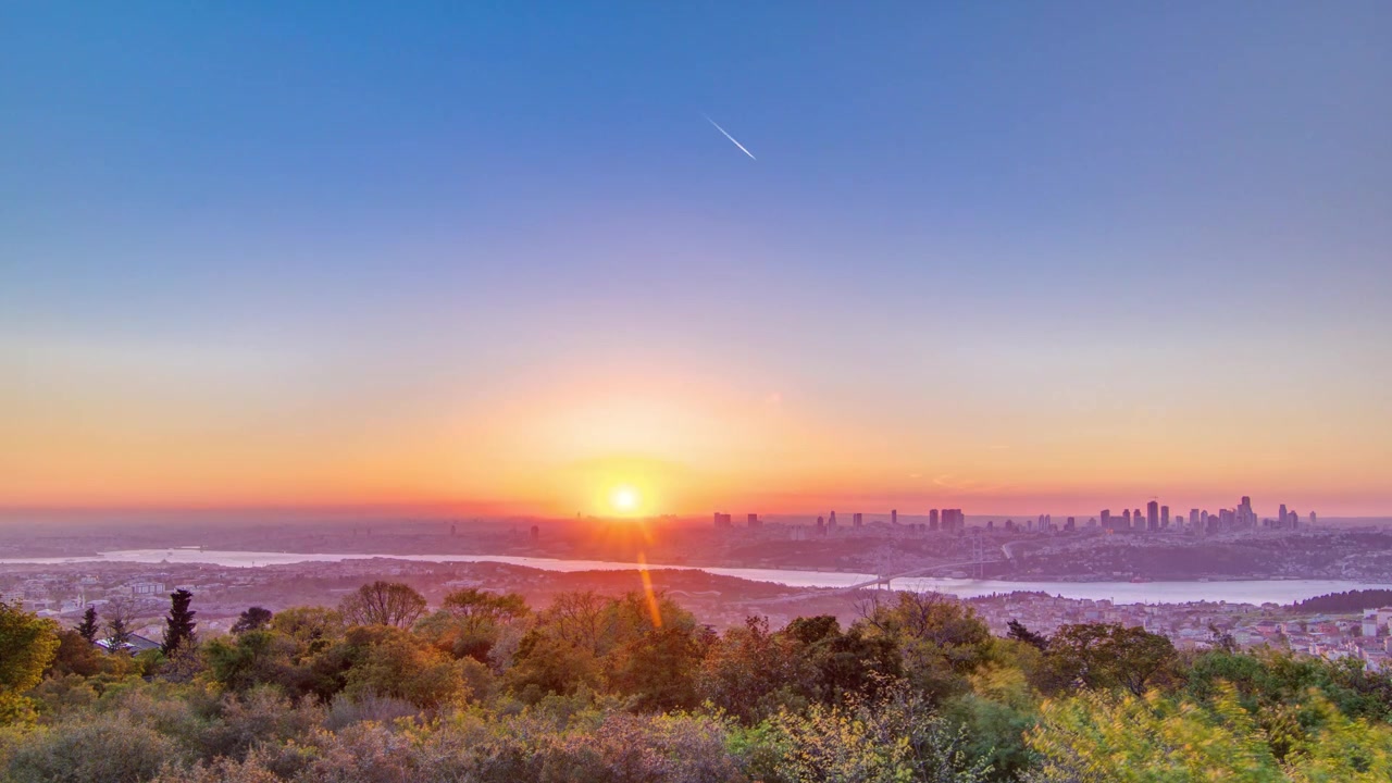 Tramonto colorato sul Bosforo timelapse dalla parte asiatica della città sulla collina di Camlica con lo skyline della città e il Ponte dei Martiri del 15 Luglio a Istanbul.