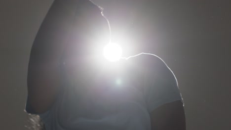 backlit head and shoulders studio portrait shot of young woman dancing in spotlight 5