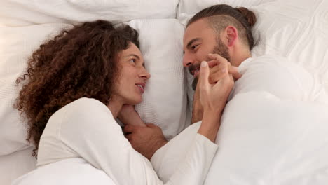 couple in bed together talking