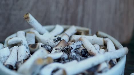 smoking cigarette in ashtray on table