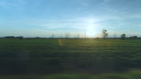 driving by the meadow field facing a beautiful sunset in lanaudière, québec
