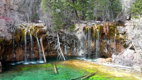 Drone-orbiting-the-Hanging-Lake-waterfalls-in-Colorado,-America