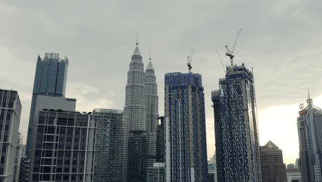 approaching the petronas twin towers in kuala lumpur, drone shot