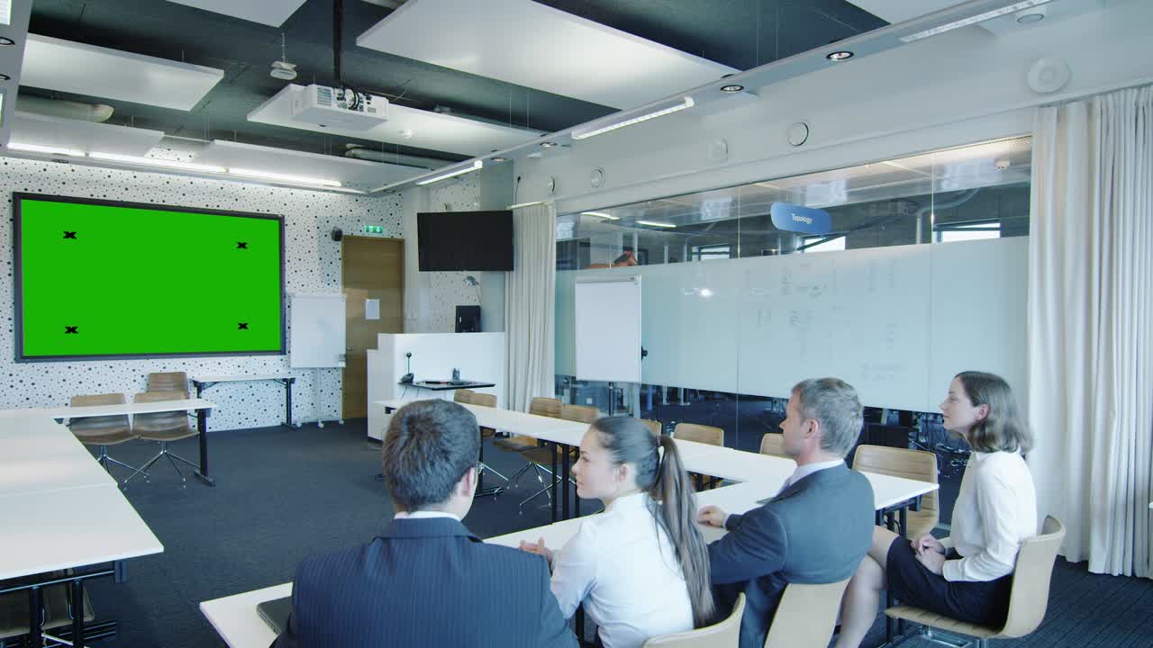 Group of Office Workers in Conference Room are Looking at Green Screen.  Great for mockup usage.