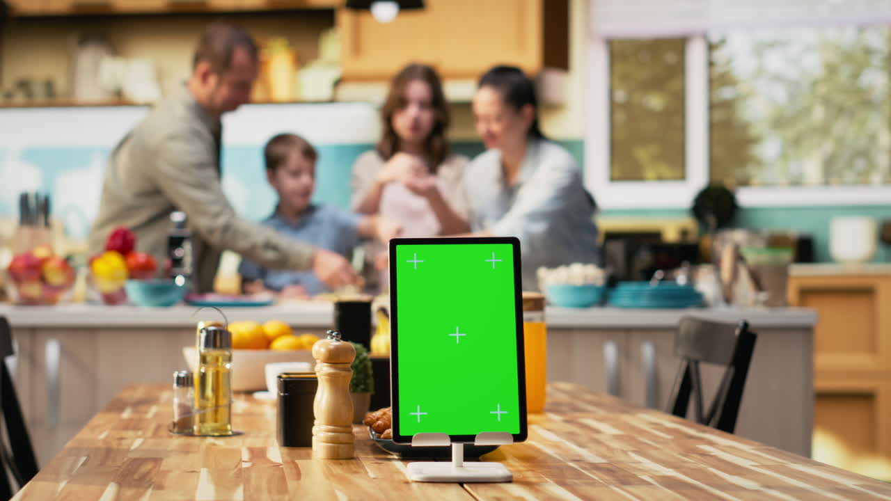 Vertical green screen on tablet with joyful family cooking pizza at home