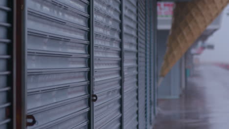 shutters down at an american pier in a rain storm, wet grey day