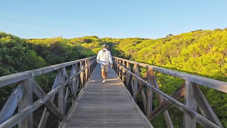 walking along the boardwalks of playa de muro beach