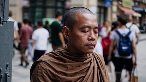 buddhist monk meditating in saffron robes, embodying mindfulness and inner peace amid the bustling chaos of a city street, reflecting serenity in everyday life
