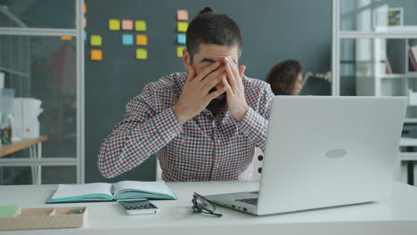 stressed office worker at laptop