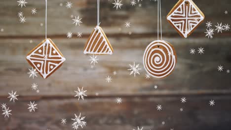 animación de nieve cayendo sobre la decoración de navidad de pan de jengibre colgado
