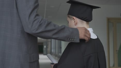 teacher touching his student's back.