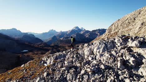 Hiker-hiking-downhill-in-the-Dolomites-in-autumn