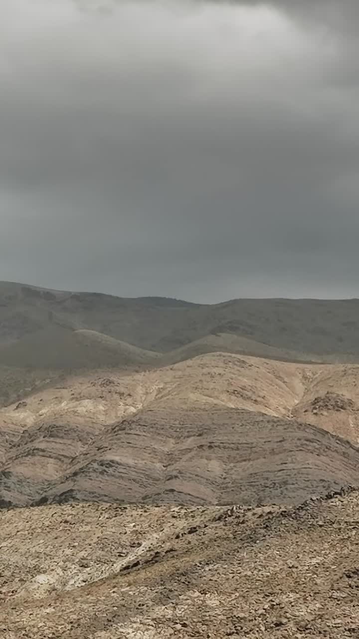 Aerial view of rocky mountains in the USA under cloudy skies