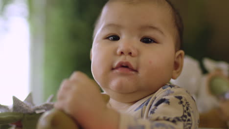 Adorable-chubby-Asian-baby-with-fat-cheeks-smiles-and-laugh-at-camera