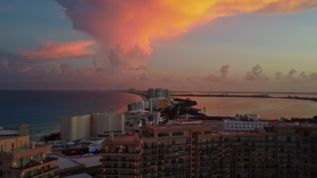 An exquisite aerial dolly shot capturing the serene sunset over Punta Cancun, Mexico