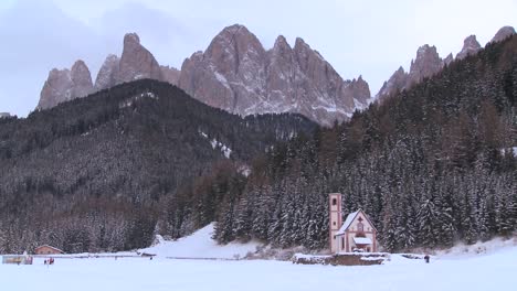 a beautiful church is nestled in the alps