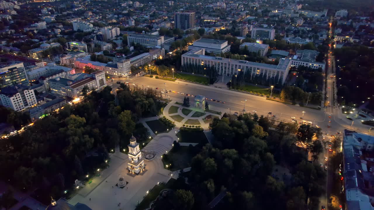 Aerial drone view of Chisinau downtown at evening, Moldova. View of Central Park, Cathedral, Goverment and a lot of greenery, buildings, illumination