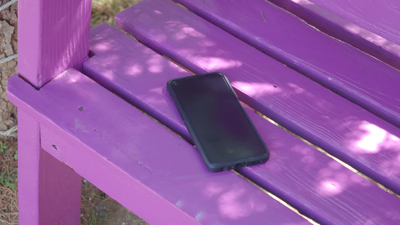 Cellphone on a purple bench