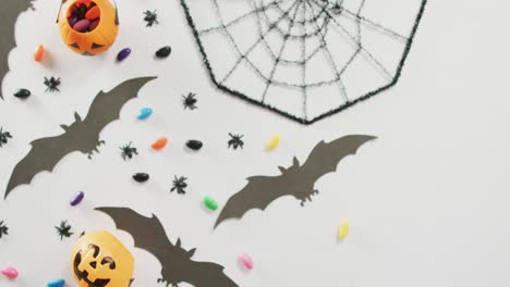 Close-up-of-multiple-halloween-toys-and-candies-on-white-background