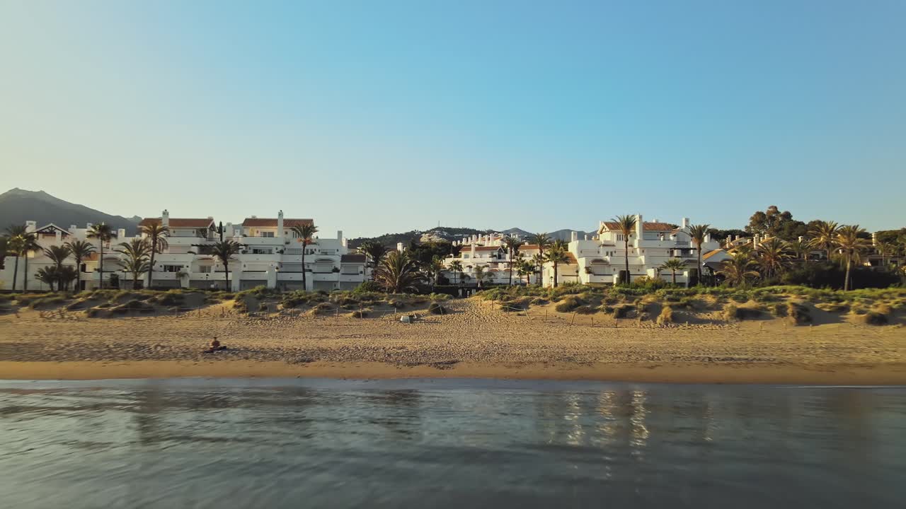 Backwards movement from the gate of a villa into the ocean