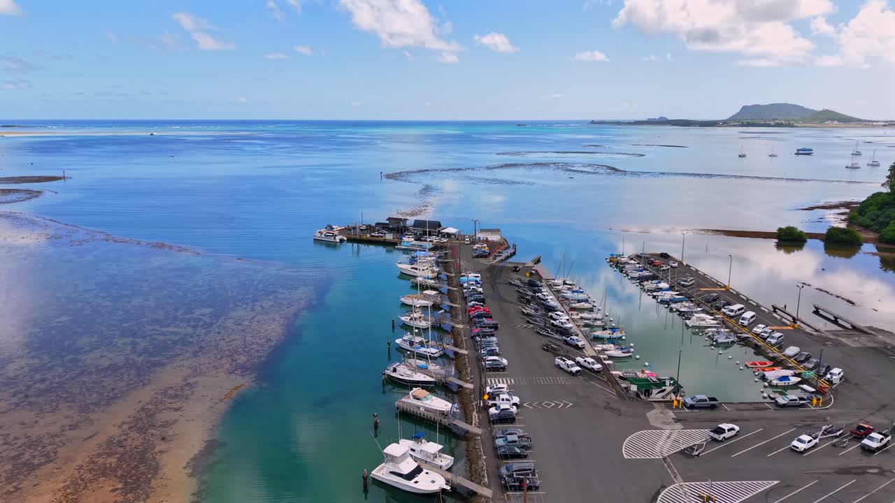 Boats docked at a harbor during low tide in Kāne'ohe Bay, Oahu, aerial