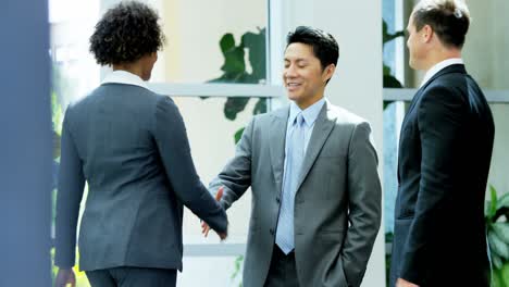 male female multi ethnic real estate team handshake