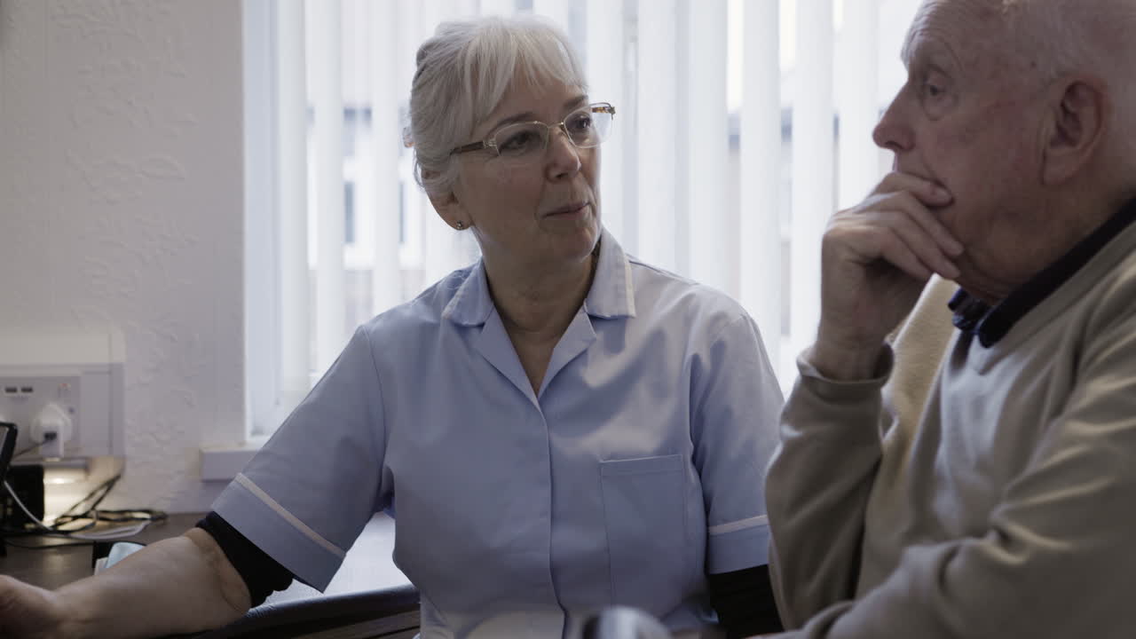 Nurse and elderly patient in conversation