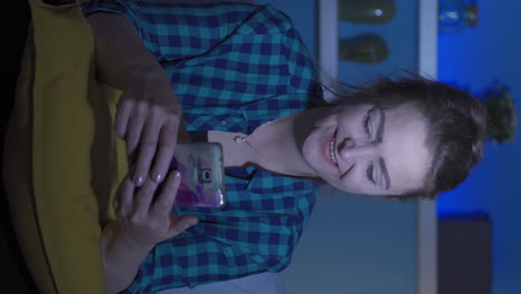 vertical video of woman texting on the phone with happy expression.