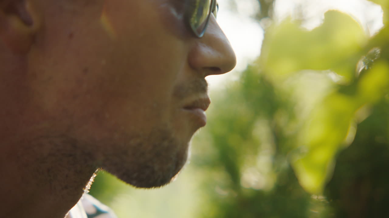 Man eating an apple outdoors