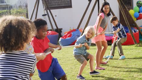 group of happy friend playing tug of war 4k