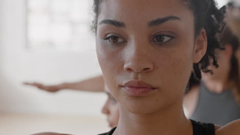 yoga class portrait young mixed race woman practicing triangle pose enjoying healthy lifestyle exercising flexible body in fitness studio