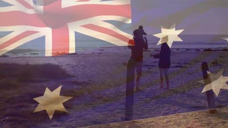 animation of flag of australia over caucasian parents with child at beach